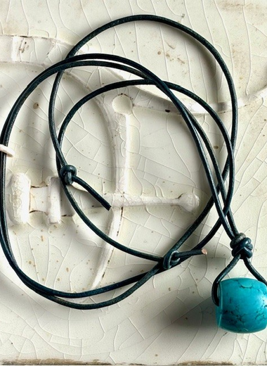 Turquoise barrel bead with gray blue leather cord