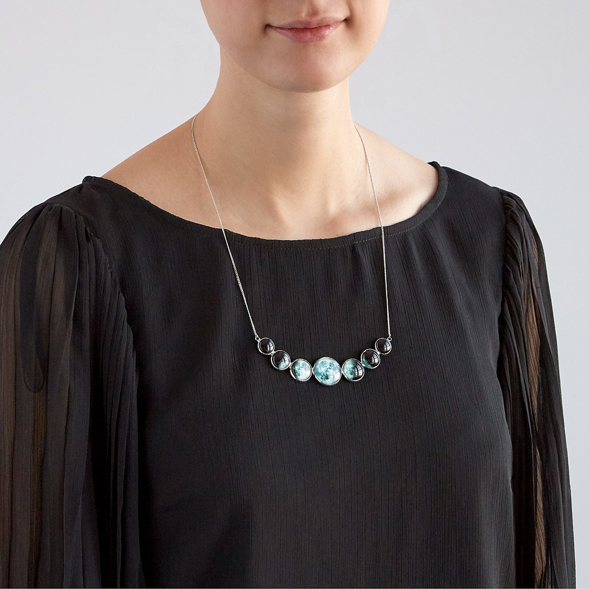 Varying Sized Curved Moon Phase Necklace in Silver