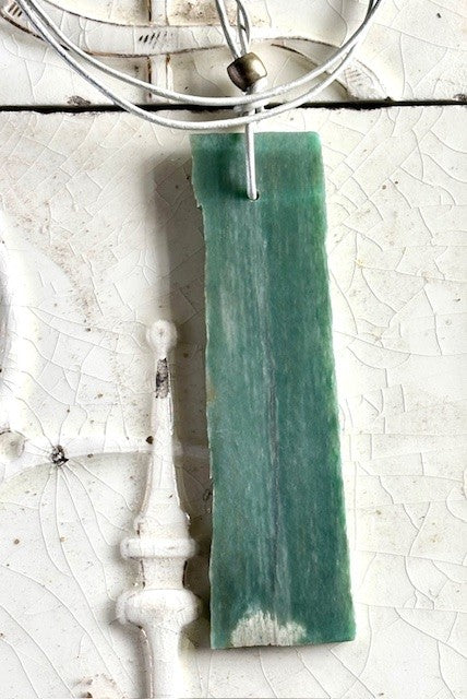 Jade slab on white leather cord