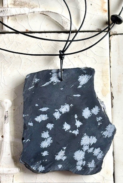Snow Flake Obsidian on black leather cord