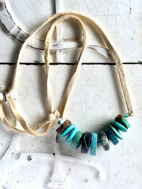 Turquoise coin beads on leather