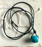Turquoise barrel bead with gray blue leather cord