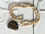 Beach rock with yellow jade beads on silk